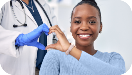 A black woman making a hearth signal with her hands and the hands of a doctor