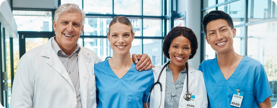 A crew of doctors and nurses smiling